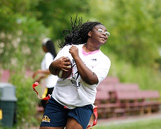 Calya Findley, 15, of Youngstown runs with the ball during the Grrridiron Girls Flag Football Camp at Glacier Field in Struthers on Tuesday. EMILY MATTHEWS | THE VINDICATOR