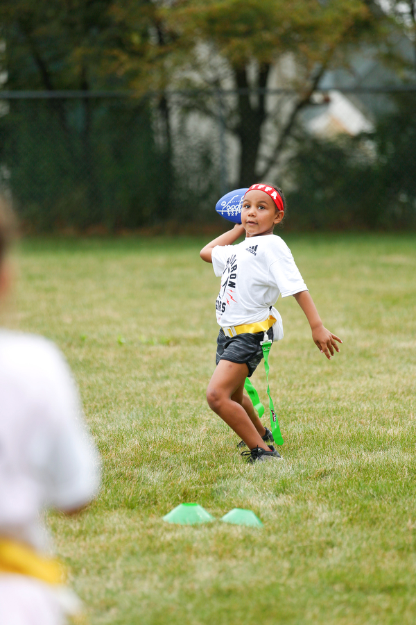 Aliyah Giles, 6, of Boardman, gets ready to throw the ball at the Grrridiron Girls Flag Football Camp at Glacier Field in Struthers on Tuesday. EMILY MATTHEWS | THE VINDICATOR