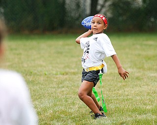 Aliyah Giles, 6, of Boardman, gets ready to throw the ball at the Grrridiron Girls Flag Football Camp at Glacier Field in Struthers on Tuesday. EMILY MATTHEWS | THE VINDICATOR