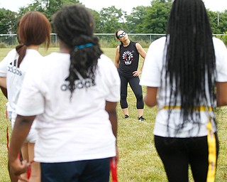 Jen Welter, the first female NFL assistant coach, talks to girls participating in the Grrridiron Girls Flag Football Camp at Glacier Field in Struthers on Tuesday. EMILY MATTHEWS | THE VINDICATOR