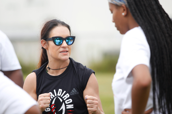 Jen Welter, the first female NFL assistant coach, talks to Donavan Gillison, 16, of Youngstown, and other girls participating in the Grrridiron Girls Flag Football Camp at Glacier Field in Struthers on Tuesday. EMILY MATTHEWS | THE VINDICATOR 