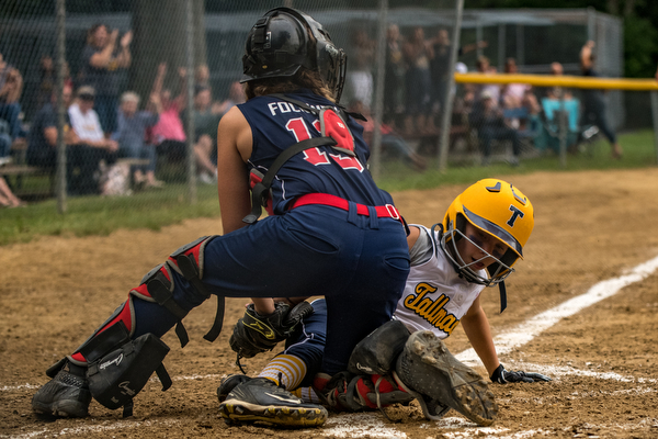 DIANNA OATRIDGE | THE VINDICATOR  Tallmadge's Marissa Charton slides into home as Austintown's Kylie Folkwein applies the tag during the loser's bracket final of the 9-10 Little League state tournament in Tallmadge. Austintown lost 7-3.