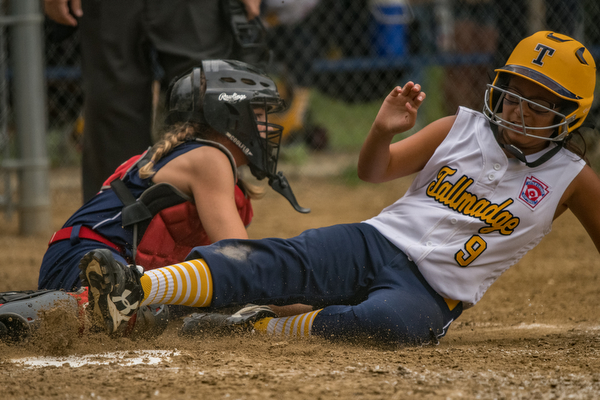 DIANNA OATRIDGE | THE VINDICATOR Austintown's Kylie Folkwein tags out Tallmadge's Gabriella Harp during the loser's bracket final of the 9-10 Little League state tournament in Tallmadge. Austintown lost 7-3.