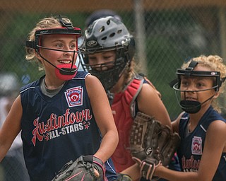 DIANNA OATRIDGE | THE VINDICATOR Austintown's Sam Severn (left), Kylie Folkwein (center), and Kali Ray (right) celebrate as they return to the dugout after a good defensive stand during the loser's bracket final of the 9-10 Little League state tournament in Tallmadge. Austintown lost 7-3.