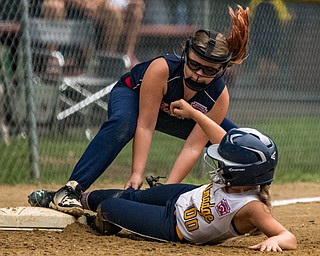 DIANNA OATRIDGE | THE VINDICATOR Austintown's Lily Stevens applies a tag on Tallmadge's Madison Birch during the loser's bracket final of the 9-10 Little League state tournament in Tallmadge. Austintown lost 7-3.