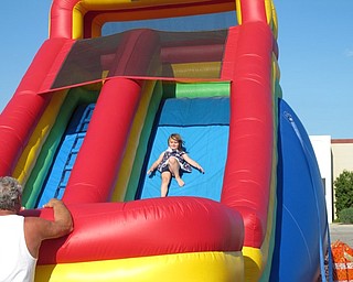 Neighbors | Jessica Harker.Madison Kovacs, age 8, slid down one of the bounce houses set up during the July 1 Austintown fireworks event in the Austintown plaza.