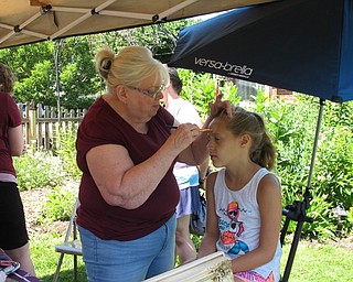 Neighbors | Jessica Harker.Elania Boyce got her face painted for free by a volunteer at the Family Fun Friday event on July 6.