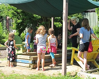Neighbors | Jessica Harker.Participants of the Family Fun Friday event played in the sand box after participating in activites on July 6 at Fellows Riverside Garden.
