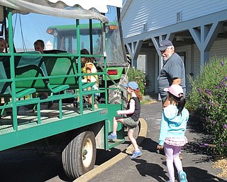 Neighbors | Jessica Harker.Children lined up to get on the tractor to go on a tour around the MetroParks farms on July 9.