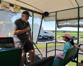 Neighbors | Jessica Harker.Instructor Bill gave information during the tractor tour of the MetroParks farms during the Food Quest camp.