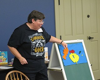 Neighbors | Jessica Harker.Karen Saunders, the childrens librarian at Boardman library, uses magnetic fish on a chalk board to read "Blue Sea," to the group of children gathered at the Family Story time July 11.