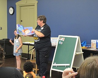 Neighbors | Jessica Harker.Librarian Karen Saunders read "Way down deep in the deep blue sea," to the group of children gathered at Family Story time July 11.