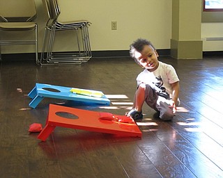 Neighbors | Jessica Harker.Glenn Barnes, age 2, played bean bag toss at the Family Story time event at the Boardman library July 11.