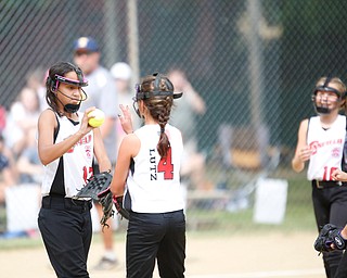 Canfield's Kyleigh Golden, left, high fives Sydney Lutz after striking out a Tallmadge player during the 10U softball state championship game at Indian Hills Field on Thursday. Canfield won 5-2. EMILY MATTHEWS | THE VINDICATOR