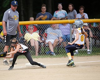 Canfield's Sam Economous catches the ball to try to get Tallmadge's Brooke Moore out during the 10U softball state championship game at Indian Hills Field on Thursday. Canfield won 5-2. EMILY MATTHEWS | THE VINDICATOR