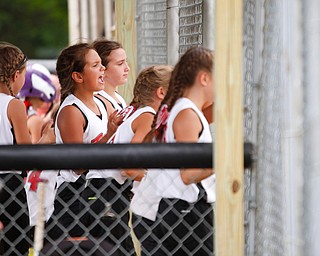 Canfield's Sydney Lutz cheers with her teammates in the dugout during the 10U softball state championship game against Tallmadge at Indian Hills Field on Thursday. Canfield won 5-2. EMILY MATTHEWS | THE VINDICATOR