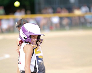 Canfield's Brooke O'Palick looks back after getting to first during the 10U softball state championship game against Tallmadge at Indian Hills Field on Thursday. Canfield won 5-2. EMILY MATTHEWS | THE VINDICATOR