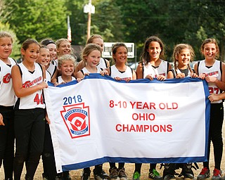 Canfield holds up their banner after winning the 10U softball state championship game against Tallmadge at Indian Hills Field on Thursday. EMILY MATTHEWS | THE VINDICATOR