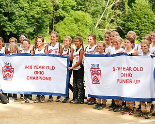 Canfield and Tallmadge hold up their banners after the 10U softball state championship game at Indian Hills Field on Thursday. EMILY MATTHEWS | THE VINDICATOR