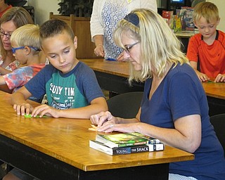 Neighbors | Jessica Harker.Anthony Williams and Renee Williams, worked to create their origami sculptures at the Paper Magic event on July 24 at the Austintown library.