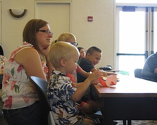 Neighbors | Jessica Harker.Nathan Skolny and his mom Kim Skolny listened to Michael Baldridge's presentation at the Paper Magic event on July 24 at the Austintown library.
