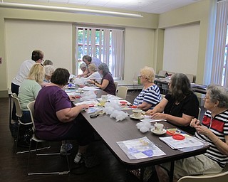 Neighbors | Natalie Wright.Participants of the Crazy Quilting program listened to instructions given by volunteers from the Youngstown Embroidery Guild before beginning their project on July 20.