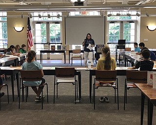 Neighbors | Jessica Harker.Librarian Karen Steed taught children various signs at the ASL camp July 26 at the Poland library.