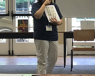 Neighbors | Jessica Harker.Librarian Karen Steed taught children the sign for orange at the Poland library ASL camp July 26.