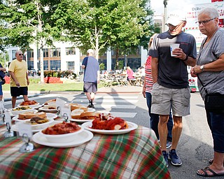 Joe and Billie Marscio, both of Warren, look at some of the food being sold by Roberto's Italian Ristorante at the Greater Youngstown Italian Fest on Friday. EMILY MATTHEWS | THE VINDICATOR