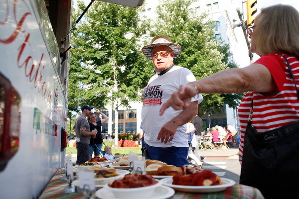 David Simon, of Youngstown, and Faye Berndt, right, of Canfield, look at some of the food being sold by Roberto's Italian Ristorante at the Greater Youngstown Italian Fest on Friday. EMILY MATTHEWS | THE VINDICATOR