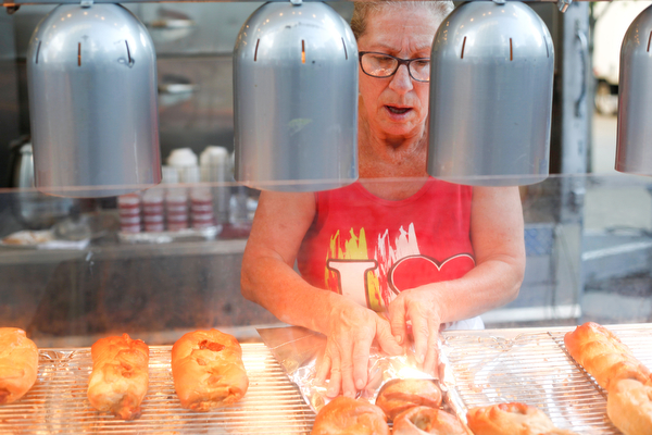 Carmela Denno, of Newton Falls, sells stromboli with Grandma Lamana's Superboli at the Greater Youngstown Italian Fest on Friday. EMILY MATTHEWS | THE VINDICATOR