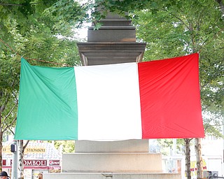 Chirrell Brown, of Cleveland, eat chicken alfredo under an Italian flag at the Greater Youngstown Italian Fest on Friday. EMILY MATTHEWS | THE VINDICATOR