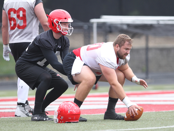 Youngstown state quarterback Montgomery VanGorder (12) prepares to take a snap frm center Vitas Hrynkiewicz (70) during practice at Stambaugh Stadium on Friday morning.  Dustin Livesay  |  The Vindicator  8/3/18  YSU