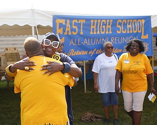Lynnette Miller, who graduated in 1969 and taught history, hugs Latanya Foster, class of 1992, at the East High School Alumni Reunion on Saturday. Foster said Miller was her African American history teacher in 1992.