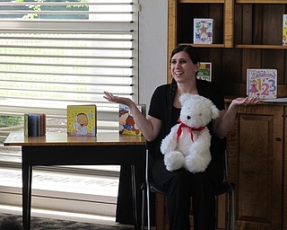 Neighbors | Jessica Harker.Librarian Taylor Cowles sang "Twinkle Twinkle Little Star," during the Baby Brilliant event July 3 at the Austintown library.