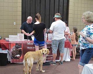 Neighbors | Jessica Harker.Erica Lehn and her father Bill Lehn, along with their dog Gena, sampled a piece of Moe's Vegan Jerky at the Austintown Farmers Market on July 2.