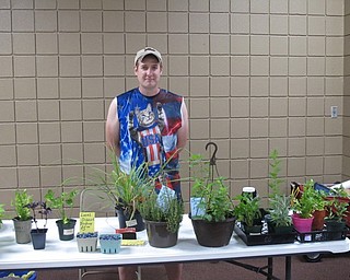 Neighbors | Jessica Harker.Jay Coy, a local of Youngstown, sold his heirloom tomatoes as well as other plants at the Austintown Farmers Market on July 2. Maters said he comes to the farmers market every Monday.