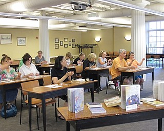 Neighbors | Jessica Harker .Participants watched as librarian Missy Williams demonstrated how to create the lava stone necklace on July 10 at the Poland library.