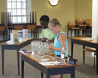 Neighbors | Jessica Harker .Malachi and Claire Sweeny picked out lava stone beads before they created their necklaces at the Poland library July 10.