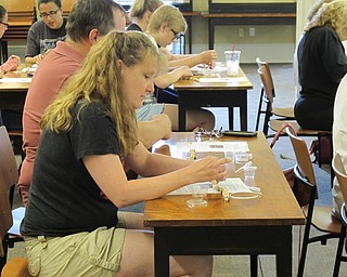 Neighbors | Jessica Harker .Kandice Aikens strung beads onto wire for the lava stone necklace making event at the Poland library July 10.