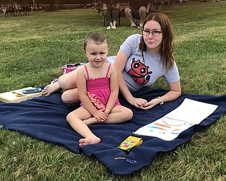 Neighbors | Jessica Harker.Jessica and Nora Wilson sat on a blanket and colored while listening to the YACCB on July 26 in Boardman Park.