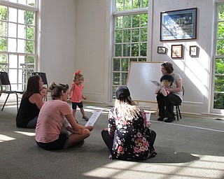 Neighbors | Jessica Harker.Librarian Amanda Kollar read a book to the group gathered at the Baby Brilliant event at the Poland library July 25.
