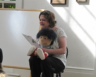 Neighbors | Jessica Harker.Librarian Amanda Kollar sang along with the group gathered at the Poland library for the Baby Brilliant event on July 25.