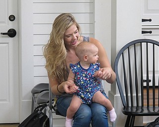 Neighbors | Jessica Harker.Rachel Predbon held her daughter, Eloise, who is nine months old, during the Baby Brilliant event July 25 at the Poland library.