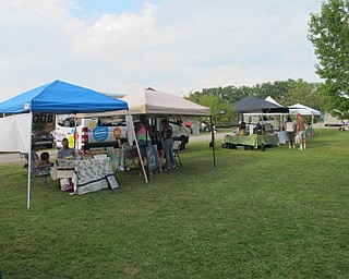 Neighbors | Jessica Harker.Stands waited in the grass for patrons to stop by on July 30 at the weekly farmers market at Austintown Park.