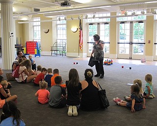 Neighbors | Jessica Harker.Librarian Amanda Kollar explained a group game to the children gathered at the third annual Ice Cream bash at the Poland library.