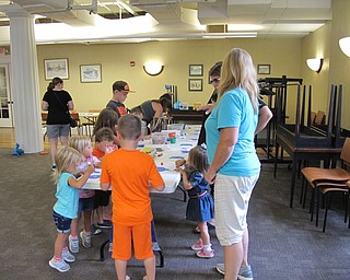 Neighbors | Jessica Harker.Children and their families make a Pete the Cat craft during the Ice Cream Bash on Aug. 2.
