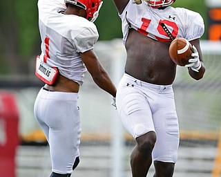 AUSTINTOWN, OHIO - AUGUST 11, 2018: Youngstown State's Charles Reeves Jr., right, celebrates with Zach Farrar after scoring a touchdown during the teams practice, Saturday morning at Austintown Fitch High School. He would score on the play. DAVID DERMER | THE VINDICATOR