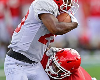 AUSTINTOWN, OHIO - AUGUST 11, 2018: Youngstown State's Christian Turner is wrapped up by Design Taylor during the teams practice, Saturday morning at Austintown Fitch High School. He would score on the play. DAVID DERMER | THE VINDICATOR