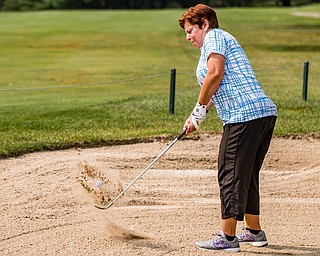 DIANNA OATRIDGE | THE VINDICATOR Diane Dofka hits her ball out of the bunker during the Ladies 2-player Championship of the Greatest Golfer of the Valley held at Trumbull Country Club in Warren on Wednesday.